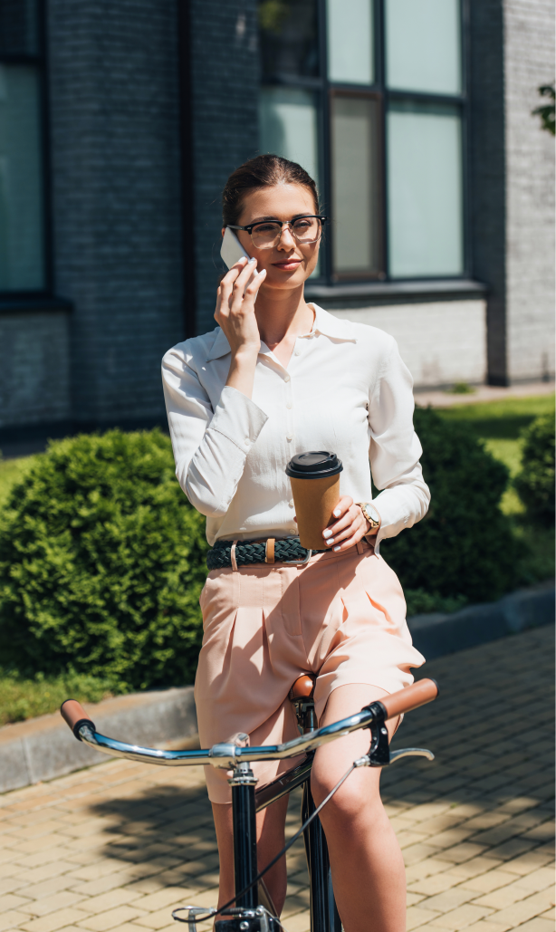 Women talking by the mobile phone in her bike.